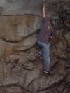 Travis teases death by dangling without safety straps on the edge of a cliff