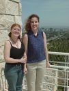 Harmony & Jill stand in fromt of the cactus garden and the Downtown Los Angeles Cityscape