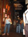 Suzanne standing outside the ground level entrance of the restaurant with the balcony seating