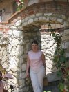 Suzanne stands in a really old archway